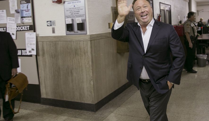 Alex Jones, a well-known Austin-based broadcaster and provocateur, arrives for a child custody trial at the Heman Marion Sweatt Travis County Courthouse in Austin, Texas, on Wednesday April 19, 2017.  Kelly Jones is seeking sole or joint custody of the couples&#39; children, ages 14, 12 and 9. (Jay Janner/Austin American-Statesman via AP)