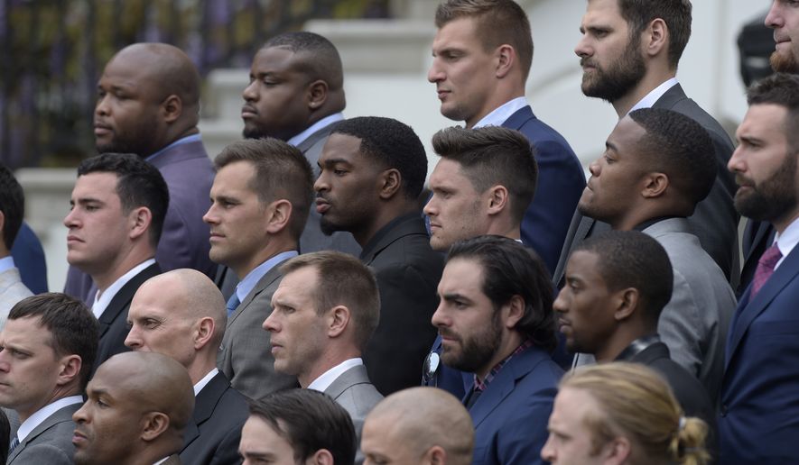 Members of the New England Patriots, including tightend Robert Gronkowski, top center right, listen as President Donald Trump speaks during a ceremony on the South Lawn of the White House in Washington, Wednesday, April 19, 2017, where the president honored the Super Bowl Champion New England Patriots for their Super Bowl LI victory. (AP Photo/Susan Walsh)