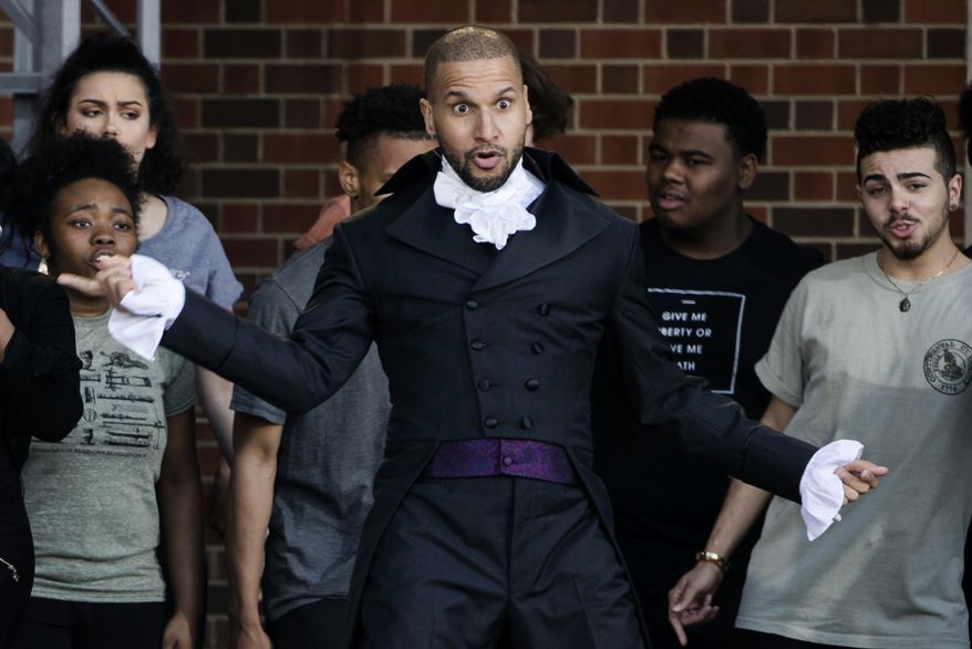 Sydney James Harcourt, an original cast member from the Broadway musical "Hamilton" performs with students from the Philadelphia High School for the Creative and Performing Arts during opening ceremonies for the Museum of the American Revolution in Philadelphia, Wednesday, April 19, 2017. (AP Photo/Matt Rourke)