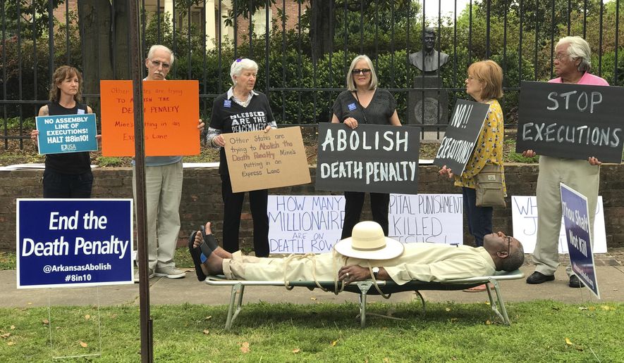 FILE - This April 14, 2017, file photo provided by Sherry Simon shows Pulaski County Circuit Judge Wendell Griffen taking part of an anti-death penalty demonstration outside the Governor&#39;s Mansion in Little Rock, Ark. Griffen, who participated in the demonstration after issuing an order blocking the state&#39;s executions is defending the move, saying his ruling was guided by property law and not his views on capital punishment. The state Supreme Court on Monday, April 17 lifted Griffen&#39;s order and prohibited the judge from considering any death penalty-related cases. (Sherry Simon via AP, File)