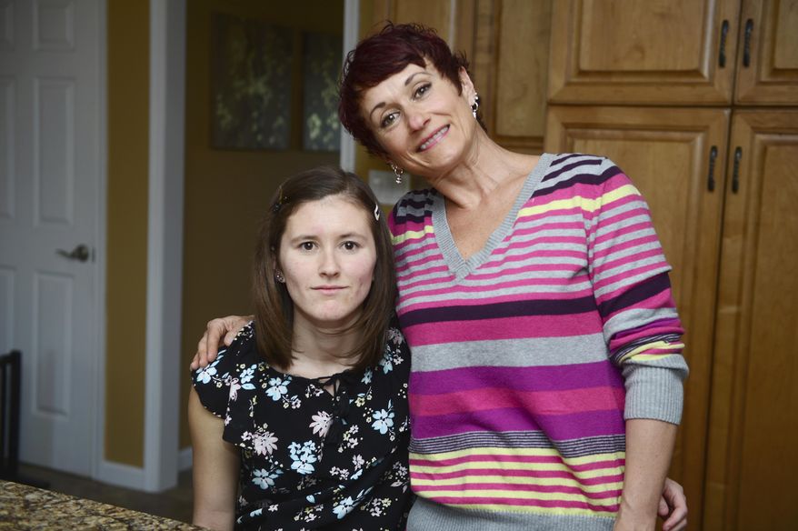 In this April 14, 2017 photo, Holly Hyzinski, left, who is slated to work at Dorney Park's Wild Water Kingdom poses for a photo with her mom, Diane Hyzinski in Orefield, Pa. Real World Lehigh Valley, a 6-week summer program run by the Center for Independent Living's School-2-Life group, aims to help other families discover what the Hyzinskis did — the transition from school and adulthood for those with disabilities doesn't need to be so intimidating. (Chris Shipley/The Morning Call via AP)