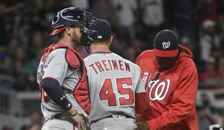 Washington Nationals pitcher Blake Treinen (45) is pulled from the baseball game by manager Dusty Baker, right, as catcher Matt Wieters stands by, after the Atlanta Braves loaded the bases during the ninth inning Tuesday, April 18, 2017, in Atlanta. Washington won 3-1. (AP Photo/John Amis)
