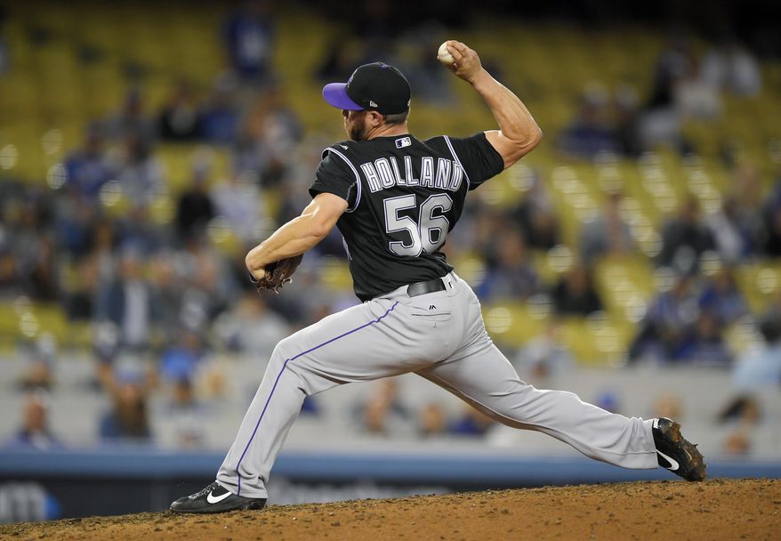Colorado Rockies relief pitcher Greg Holland throws to the plate during the ninth inning of the team's baseball game against the Los Angeles Dodgers, Tuesday, April 18, 2017, in Los Angeles. (AP Photo/Mark J. Terrill)