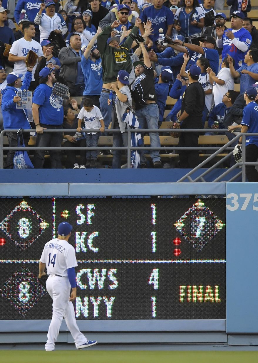 Los Angeles Dodgers left fielder Enrique Hernandez watches a two-run home run by Colorado Rockies' Nolan Arenado during the first inning of a baseball game, Tuesday, April 18, 2017, in Los Angeles. (AP Photo/Mark J. Terrill)