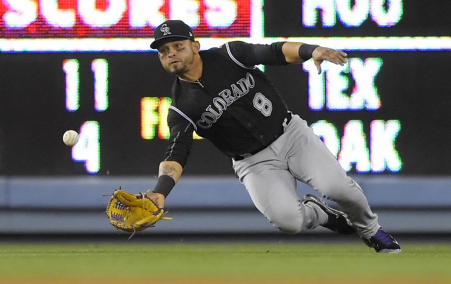 Colorado Rockies left fielder Gerardo Parra can't get to a ball hit for a single by Los Angeles Dodgers' Corey Seager during the ninth inning of a baseball game, Tuesday, April 18, 2017, in Los Angeles. (AP Photo/Mark J. Terrill)