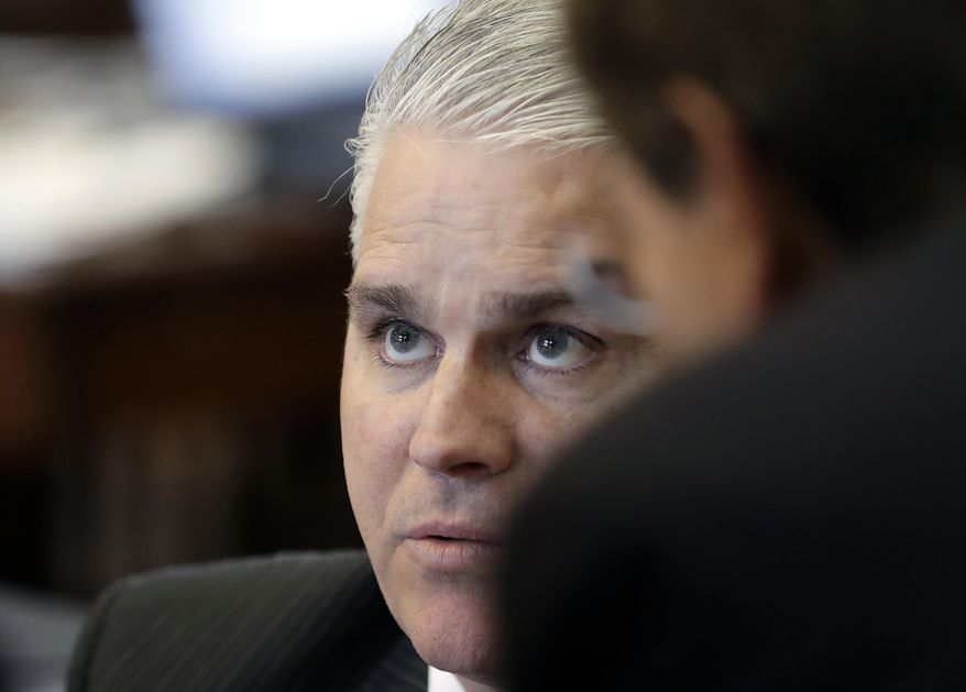 Rep. Dan Huberty, R-Houston, talks with fellow law makers on the house floor Wednesday, April 19, 2017, in Austin, Texas. Huberty, Chair of the House Public Education Committee, is the sponsor of House Bill 21 which would put money into the school system. (AP Photo/Eric Gay)