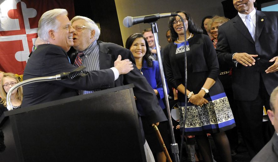 Maryland Gov.-elect Larry Hogan, left, a Republican, hugs his father, former U.S. Congressman Lawrence Hogan, second from left, after beating Democrat Anthony Brown, not pictured, in the state&#x27;s gubernatorial race Wednesday, Nov. 5, 2014 in Annapolis, Md. Also standing on stage with Hogan are his wife Yumi, third from left, running mate Boyd Rutherford, right, and Rutherford&#x27;s wife, Monica, second from right. (AP Photo/Steve Ruark)