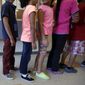 In this Sept. 10, 2014, file photo, detained immigrant children line up in the cafeteria at the Karnes County Residential Center, a temporary home for immigrant women and children detained at the border, in Karnes City, Texas. (AP Photo/Eric Gay, File)