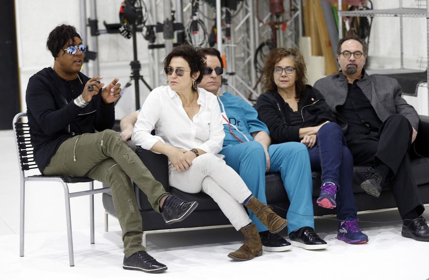 Bassist BrownMark, left, answers a question as the original members of Prince's 1980's band, The Revolution, from second left, guitarist Wendy Melvoin, keyboarders Matt Fink and Lisa Coleman and drummer Bobby Z, look on during an interview, Wednesday, April 19, 2017, in Minneapolis. The group is preparing to kick off a spring U.S. tour with a performance Friday, the first anniversary of the Prince's death from an accidental overdose. (AP Photo/Jim Mone)