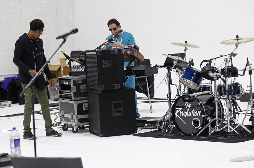 Keyboarder Matt Fink, right, and bassist BrownMark prepare for rehearsal after the original members of Prince's 1980's band, The Revolution, were interviewed Wednesday, April 19, 2017 at a studio in Minneapolis. The group is back, preparing to kick off a spring U.S. tour with a performance Friday, the first anniversary of the Prince's death from an accidental painkiller overdose. (AP Photo/Jim Mone)
