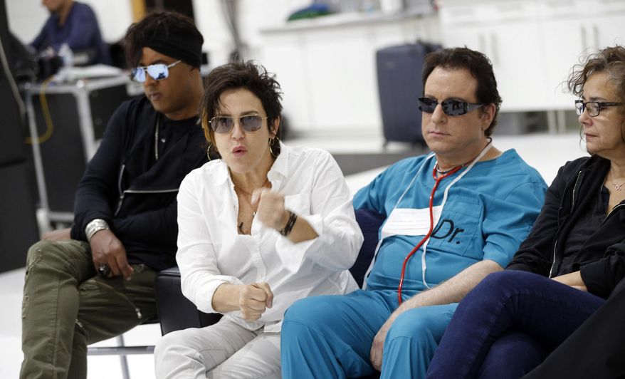 Guitarist Wendy Melvoin, second from left, answers a question as the original members of Prince's 1980's band, The Revolution, are interviewed Wednesday, April 19, 2017, at a studio in Minneapolis. The group, from left: bassist BrownMark, Melvoin, keyboarders Matt Fink and Lisa Coleman, is back, preparing to kick off a spring U.S. tour with a performance Friday, April 21, 2017, the first anniversary of the Prince's death from an accidental painkiller overdose. (AP Photo/Jim Mone)