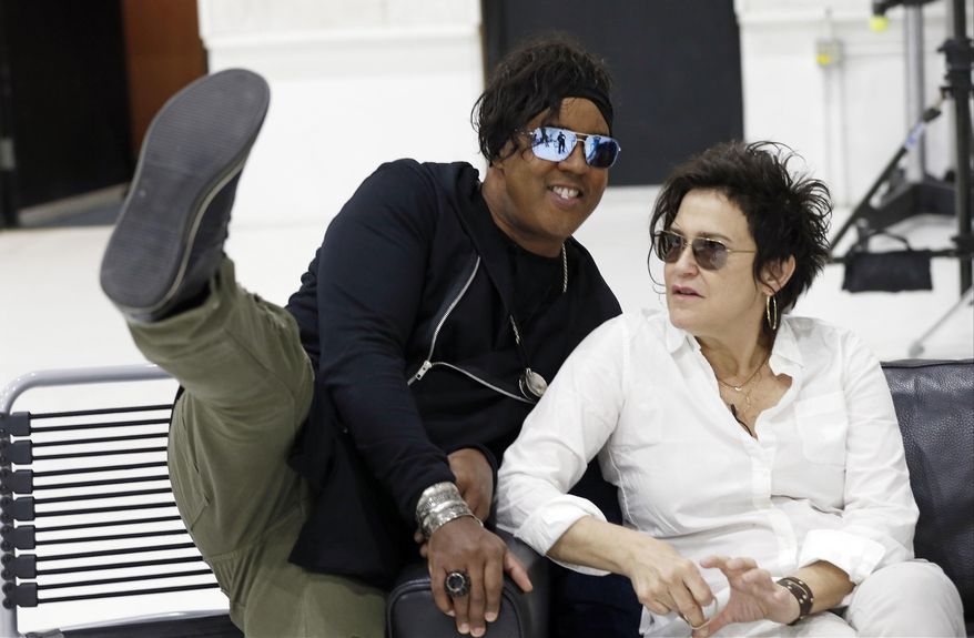 Bassist BrownMark, left, jokes around with guitarist Wendy Melvoin as the original members of Prince's 1980's band, The Revolution, prepared for an interview Wednesday, April 19, 2017, in Minneapolis. The group is preparing to kick off a spring U.S. tour with a performance Friday, the first anniversary of the Prince's death from an accidental painkiller overdose. (AP Photo/Jim Mone)