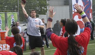 FILE - In this April 25, 2012, file photo, Andrew Luck, center left, throws the ball during the NFL Play 60 Youth Football Festival in New York. When the NFL launched Play 60 a decade ago as a way to get American youth active, the league had no idea what kind of reach the program would have. Ten years later, millions of youngsters and 73,000 schools have become involved, and affiliations with such organizations as the American Heart Association and the National Dairy Council have helpoed make Play 60 one of the nation&#x27;s most effective anti-obesity and children&#x27;s activity initiatives in the land.(AP Photo/Mary Altaffer, File)