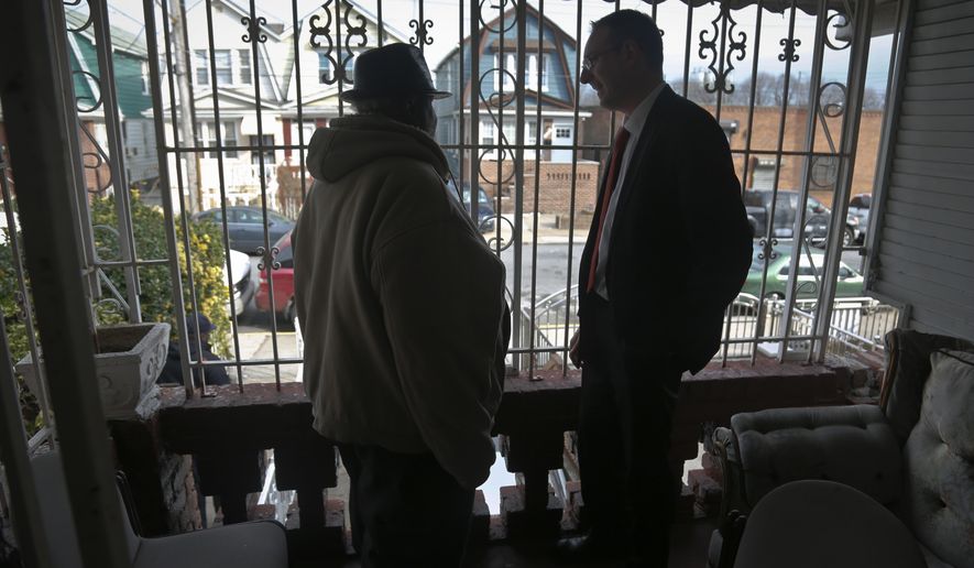 ADVANCE FOR USE SUNDAY, APRIL 23, 2017 AND THEREAFTER-In this Feb. 1, 2017, photo, Raymond Murray gets a visit from his lawyer, Robert Seewald, right, at his home in New York. Murray is the victim of deed theft, a foreclosure fraud where older people are mostly the target. (AP Photo/Bebeto Matthews)