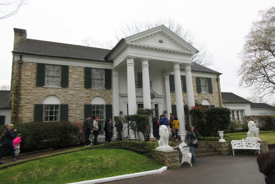 This March 13, 2017 photo shows visitors getting ready to tour Graceland in Memphis, Tenn. Elvis Presley bought the mansion _ which is small by 21st century standards _ in 1957 and lived there until his death 20 years later. (AP Photo/Beth J. Harpaz)