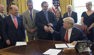 President Trump hands United Steel Workers International President Leo W. Gerard the pen he used to sign an executive memorandum on investigation of steel imports on Thursday. Commerce Secretary Wilbur L. Ross Jr. is on the left. (Associated Press)