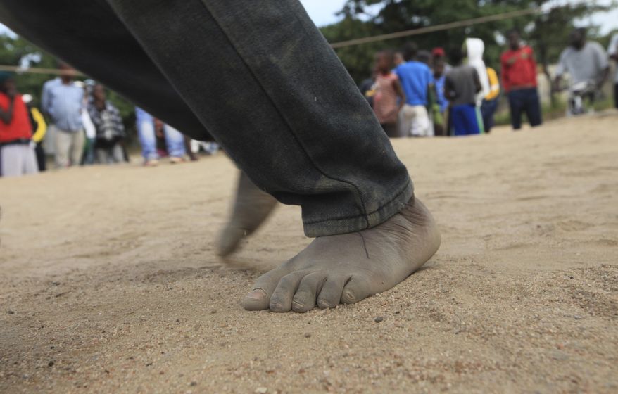 In this Sunday, March 11, 2017 photo, children fight in a boxing ring in Chitungwiza, Zimbabwe. Zimbabwean boys as young as 10 hurry every weekend to a boxing ring whose nickname, Wafa Wafa, in the local Shona language suggests that whoever enters will be lucky to come out alive. (AP Photo/Tsvangirayi Mukwazhi)