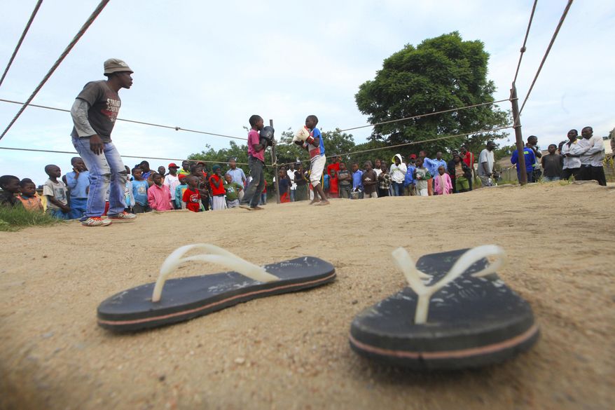 In this Sunday, March 11, 2017 photo, children fight in a boxing ring in Chitungwiza, Zimbabwe. Zimbabwean boys as young as 10 hurry every weekend to a boxing ring whose nickname, Wafa Wafa, in the local Shona language suggests that whoever enters will be lucky to come out alive. (AP Photo/Tsvangirayi Mukwazhi)