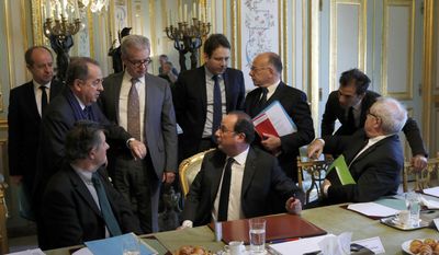 French President Francois Hollande, sitting at center, speaks with ministers and officials at the end of a defense council at the Elysee Palace in Paris, France, Friday, April 21, 2017. From the left seated : General Secretary of the Elysee Palace Jean-Pierre Jouyet, President Francois Hollande, Navy Chief of staff Admiral Bernard Rogel. From the left standing standing : Justice Minister Jean-Jacques Urvoas, Paris Prefect Michel Delpuech, Hollande&#x27; s cabinet director Jean-Pierre Hugues, Interior Minister Matthias Fekl, Prime Minister Bernard Cazeneuve and communication advisor Gaspard Gantzer. (Philippe Wojazer, Pool via AP)