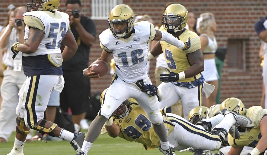 Georgia Tech White Team quarterback TaQuon Marshall (16) runs past Gold Team defensive lineman Desmond Branch (99) during the NCAA college football team's spring game, Friday, April 21, 2017, in Atlanta. (Hyosub Shin/Atlanta Journal-Constitution via AP)