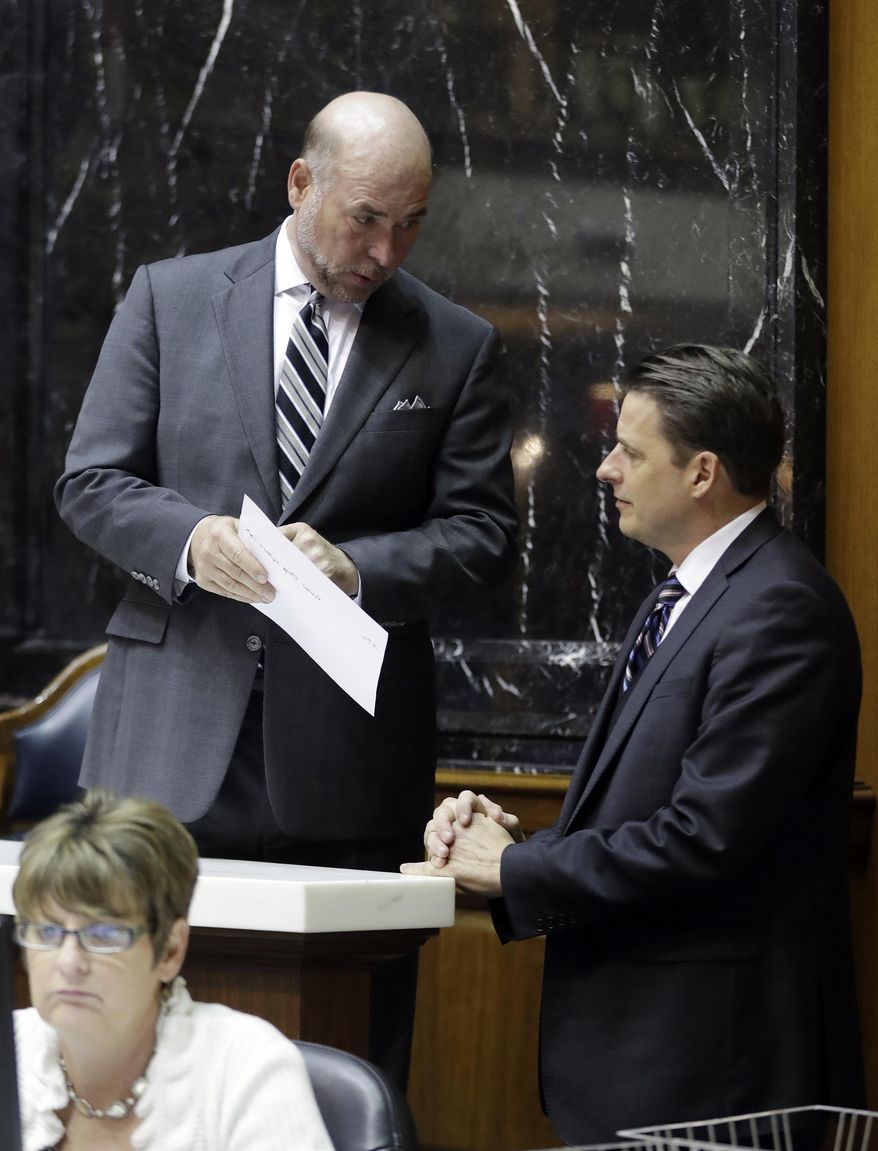 Speaker of the House Brian Bosma, left, R-Indianapolis, talks with House Minority Leader Scott Pelath, D-Michigan City, during the session at the Statehouse Friday, April 21, 2017, in Indianapolis. (AP Photo/Darron Cummings)