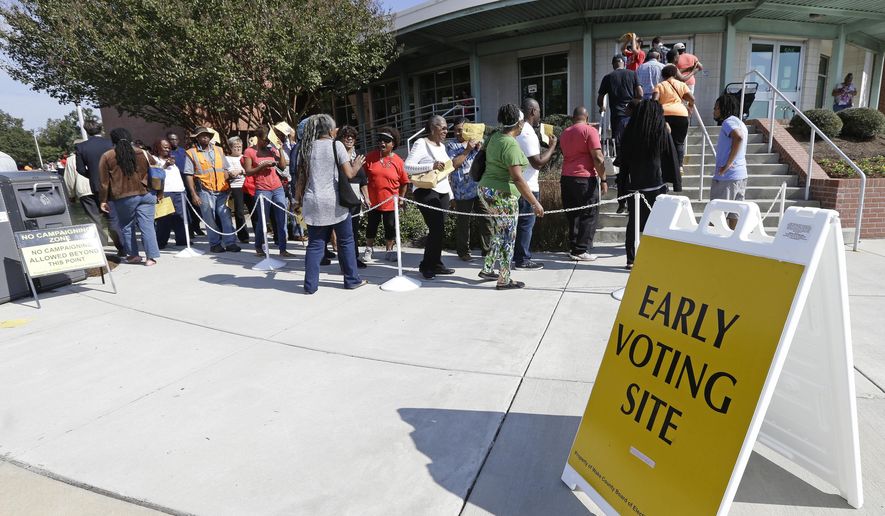 In this Oct. 20, 2016, photo, voters line up during early voting at Chavis Community Center in Raleigh, N.C. According to an audit released April 21, 2017, North Carolina elections officials found that about 500 ineligible voters cast ballots in the 2016 general election — but not enough to change the outcome of any race. (AP Photo/Gerry Broome) **FILE**