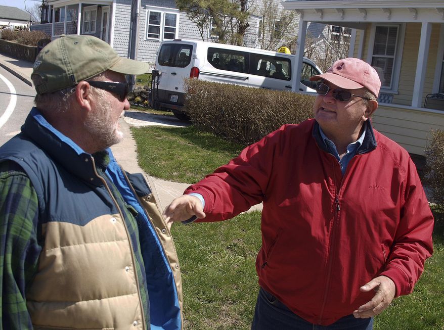 In this Tuesday, April 11, 2017 photo, Champlin Starr, left, talks with Leslie Slate in New Shoreham, R.I. The two men are among several dozen taxi drivers on Block Island. The community has had its own taxi rules since 1929. The wait to get a taxi license is about 15 years. (AP Photo/Matt O'Brien)