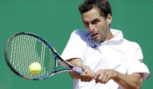 Spain's Albert Ramos-Vinolas returns the ball to Croatia's Marin Cilic during their quarterfinal match of the Monte Carlo Tennis Masters tournament in Monaco, Friday, April, 21, 2017. (AP Photo/Claude Paris)