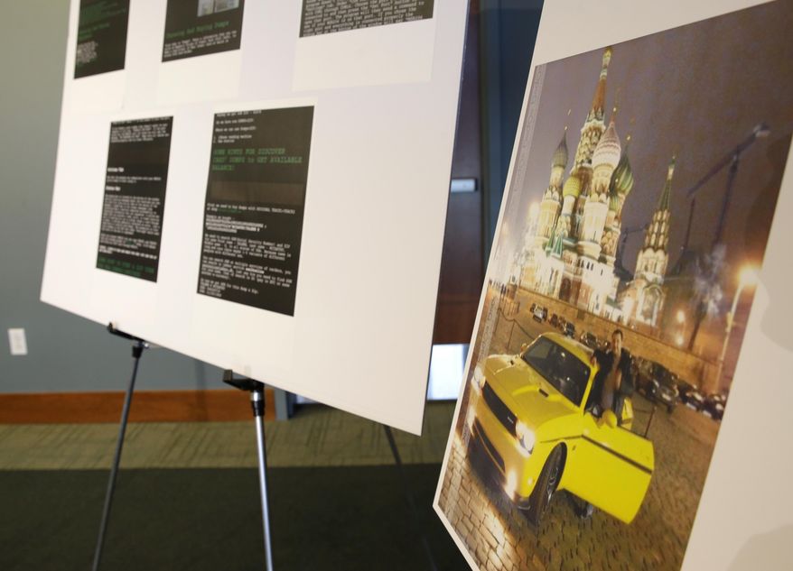 A photo of Russian hacker Roman Seleznev posing with a sports car near the Kremlin is displayed for reporters Friday, April 21, 2017, in Seattle, next to screenshots of instructions he posted online on how to steal credit card data, following the federal court sentencing of Seleznev to 27 years in prison after he was convicted of hacking into U.S. businesses to steal credit card data. (AP Photo/Ted S. Warren)