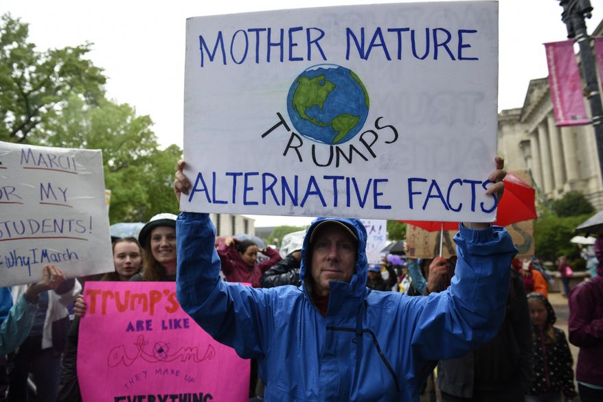 A man carries a sign during the March for Science in Washington, Saturday, April 22, 2017. Scientists, students and research advocates rallied from the Brandenburg Gate to the Washington Monument on Earth Day, conveying a global message of scientific freedom without political interference and spending necessary to make future breakthroughs possible. (AP Photo/Sait Serkan Gurbuz)