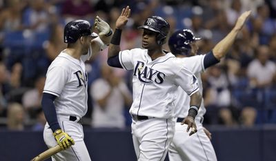 Tampa Bay Rays&#39; Tim Beckham, center, celebrates with Shane Peterson, right, and Evan Longoria, left, after scoring on a two-run single by Peter Bourjos off Houston Astros relief pitcher Will Harris during the sixth inning of a baseball game Saturday, April 22, 2017, in St. Petersburg, Fla. (AP Photo/Chris O&#39;Meara)