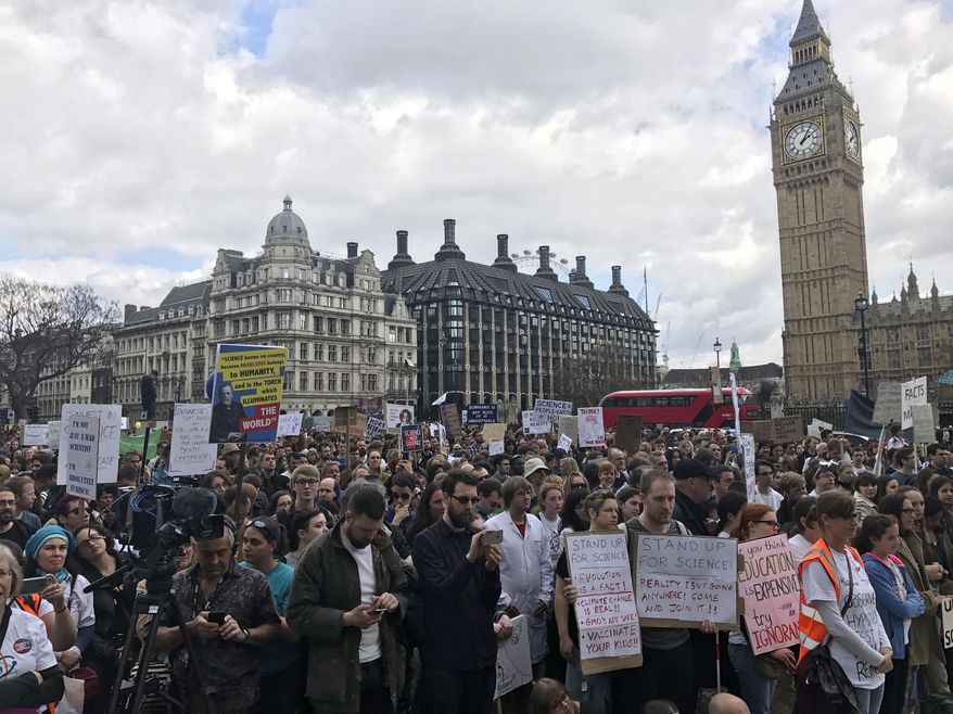 Scientists protest in Parliament Square, central London, during the March for Science, Saturday, April 22, 2017. Thousands of scientists worldwide made plans to leave their labs and take to the streets Saturday to rail against what they say are mounting attacks against science. (Jack Hardy/PA via AP)