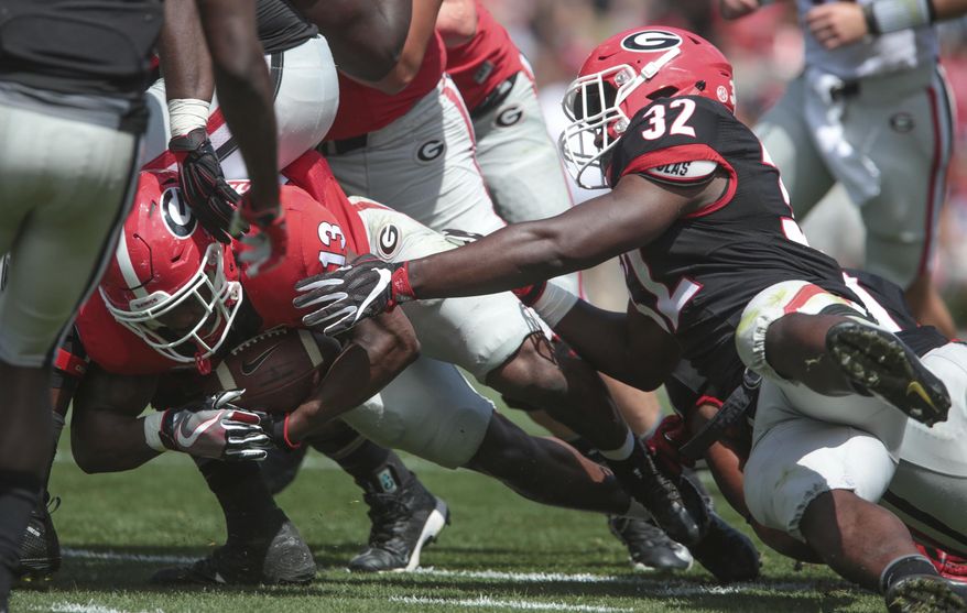 Georgia running back Elijah Holyfield (13) moves the ball downfield during Georgia's G Day spring NCAA college fotoball game at Sanford Stadium in Athens, Ga., Saturday, April 22, 2017. John Roark/Athens Banner-Herald via AP)