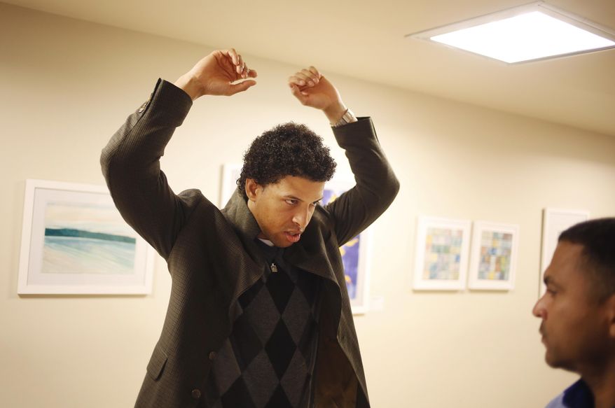 In this Thursday, April 20, 2017 photo, Neftali Thomas Diaz tries on donated work clothes at The Fortune Society in New York. At the Fortune Society, one of the social service nonprofits expected to partner with the city on the plan and a sponsor of Diaz, the mission is proving the critics wrong by training former state prison and jail inmates on how to land and keep jobs. (AP Photo/Seth Wenig)