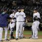 Seattle Mariners starting pitcher Hisashi Iwakuma, center, is pulled from the baseball game by manager Scott Servais during the sixth inning against the Oakland Athletics on Friday, April 21, 2017, in Oakland, Calif. (AP Photo/Marcio Jose Sanchez)
