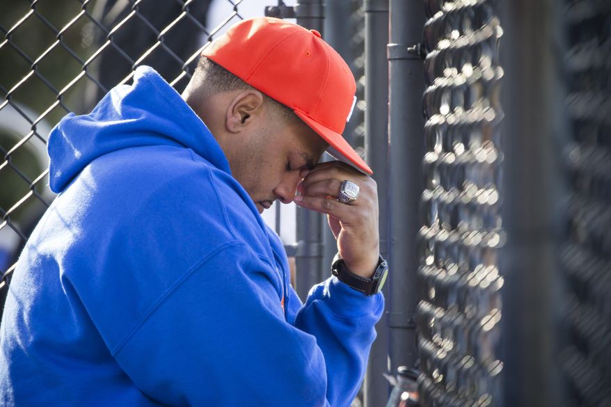 Rainier Beach coach Gerald Smiley looks down as the Vikings lose their lead in the third inning to Bishop Blanchet for a Metro League game at home Wednesday March 29, 2017. The Rainier Beach High School Vikings baseball team was given no money this year and had to fundraise to save their season. They raised over $42,000 through GoFundMe. (Bettina Hansen /The Seattle Times via AP)
