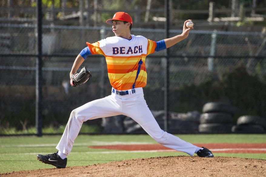 Starting pitcher Gregorio Reyes of Rainier Beach throws while the Vikings play Bishop Blanchet for a Metro League game at home Wednesday March 29, 2017. The Rainier Beach High School Vikings baseball team was given no money this year and had to fundraise to save their season. They raised over $42,000 through GoFundMe. (Bettina Hansen /The Seattle Times via AP)