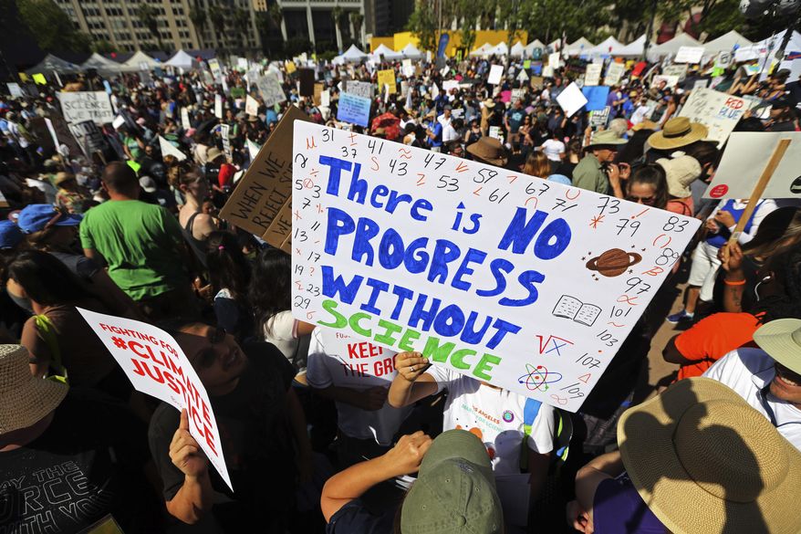 Demonstrators at Pershing Square in downtown Los Angeles, take part in the March for Science, Saturday, April 22, 2017. They chanted "Money for science and education, not for wars and climate alteration." (AP Photo/Reed Saxon)