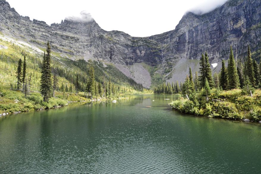 FILE - This Sept. 9 2016 file photo, shows a view of Upper Snyder Lake in Glacier National Park, Mont. Montana might be known internationally for such recreational jewels as Glacier and Yellowstone national parks, but Native Americans say the state is losing an opportunity by failing to develop and promote its vast tribal lands as tourist destinations. (Lewis Kendall/Bozeman Daily Chronicle via AP, File)
