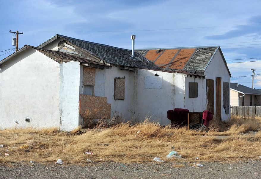FILE - This Feb. 10, 2016 file photo shows a boarded up home in an area known as "Moccasin Flats" on the Blackfeet Reservation in Browning, Mont. Native Americans say the state needs to do more to develop and promote its vast tribal lands as tourist destinations. (Rion Sanders/The Great Falls Tribune via AP, File)