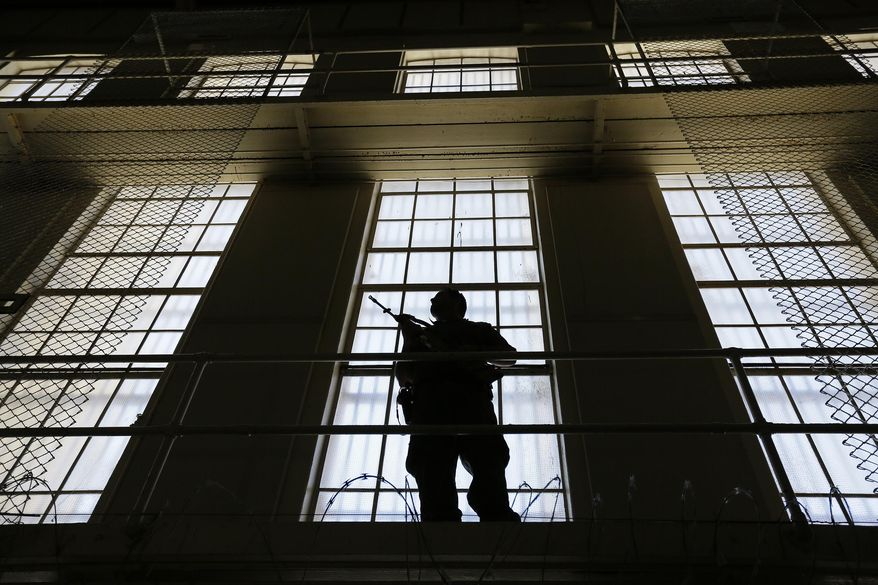 FILE - In this Aug. 16. 2016, file photo, a guard stands watch over the east block of death row at San Quentin State Prison in San Quentin, Calif. California corrections officials expect to meet a Wednesday, April 26, 2017, deadline to submit revised lethal injection rules to state regulators, trying again with technical changes after the first attempt was rejected in December. While California has long been what one expert calls "a symbolic death penalty state," the nation's most populous state may now be easing back toward allowing executions. (AP Photo/Eric Risberg, File)