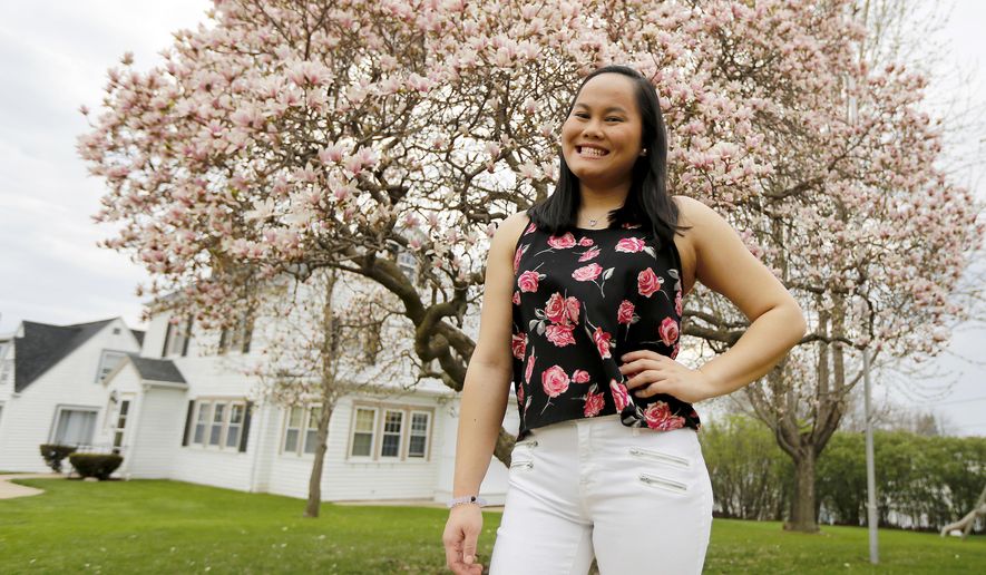 ADVANCE FOR USE SUNDAY, APRIL 23 - In this April 15, 2017 photo, Betsy Till, a Wahlert Catholic High School senior, was born with one leg shorter than the other and has gone through more than a dozen surgeries to correct the problem, poses in Dubuque, Iowa. (Eileen Meslar/Telegraph Herald via AP)
