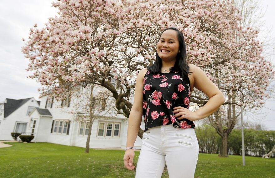 ADVANCE FOR USE SUNDAY, APRIL 23 - In this April 15, 2017 photo, Betsy Till, a Wahlert Catholic High School senior, was born with one leg shorter than the other and has gone through more than a dozen surgeries to correct the problem, poses in Dubuque, Iowa. (Eileen Meslar/Telegraph Herald via AP)