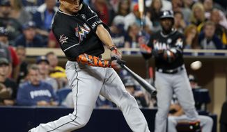 Miami Marlins&#39; Giancarlo Stanton hits a two-run home run in the eleventh inning of a baseball game against the San Diego Padres in San Diego, Saturday, April 22, 2017. The Marlins won 6-3. (AP Photo/Christine Cotter)