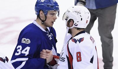 Toronto Maple Leafs center Auston Matthews (34) and Washington Capitals left wing Alex Ovechkin (8) shake hands after the Capitals defeated the Maple Leafs in Game 6 of an NHL hockey Stanley Cup first-round playoff series in Toronto on Sunday, April 23, 2017. The Capitals beat the Maple Leafs 2-1 on Sunday to capture the best-of-seven Eastern Conference quarter-final series in six games. (Frank Gunn/The Canadian Press via AP)