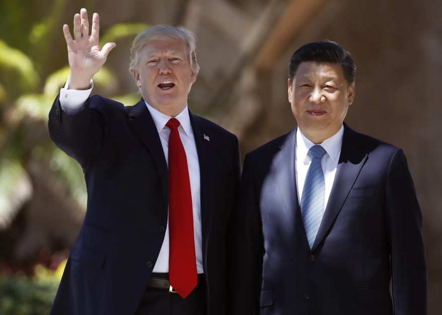 In this Friday, April 7, 2017, file photo, U.S. President Donald Trump, left, and Chinese President Xi Jinping pause for photographs at Mar-a-Lago in Palm Beach, Fla. (AP Photo/Alex Brandon, File)