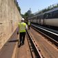 In this photo taken July 25, 2016, Metro general manager Paul Wiedefeld walks along a track that&#39;s been closed for maintenance while an orange line train rolls along the other track in northern Virginia.  (AP Photo/Ben Nuckols) **FILE**
