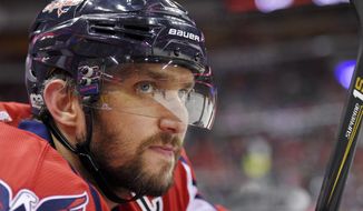 FILE - In this Tuesday, March 14, 2017, file photo, Washington Capitals left wing Alex Ovechkin (8), of Russia, looks on from the bench during the first period of an NHL hockey game against the Minnesota Wild in Washington. To get to their first Eastern Conference final in the past decade, Alex Ovechkin and the Washington Capitals will have to go through the Sidney Crosby and Pittsburgh Penguins, who have quite simply had their number in the playoffs. (AP Photo/Nick Wass, File)