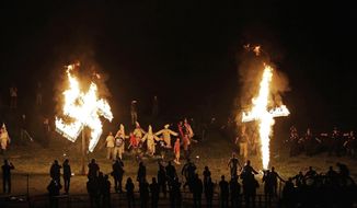 In this April 23, 2016 file photo, members of the Ku Klux Klan participate in cross and swastika burnings after a &amp;quot;white pride&amp;quot; rally in rural Paulding County near Cedar Town, Ga. (AP Photo/Mike Stewart)