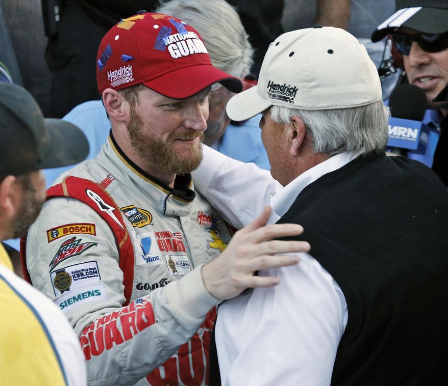 In this Oct. 26, 2014, file photo, Dale Earnhardt Jr. celebrates winning the NASCAR Sprint Cup Series auto race with team owner Rick Hendrick, front right, in Victory Lane at Martinsville Speedway in Martinsville, Va. Hendrick Motorsports says Dale Earnhardt Jr. will retire at the end of this season. (AP Photo/Steve Helber, File)